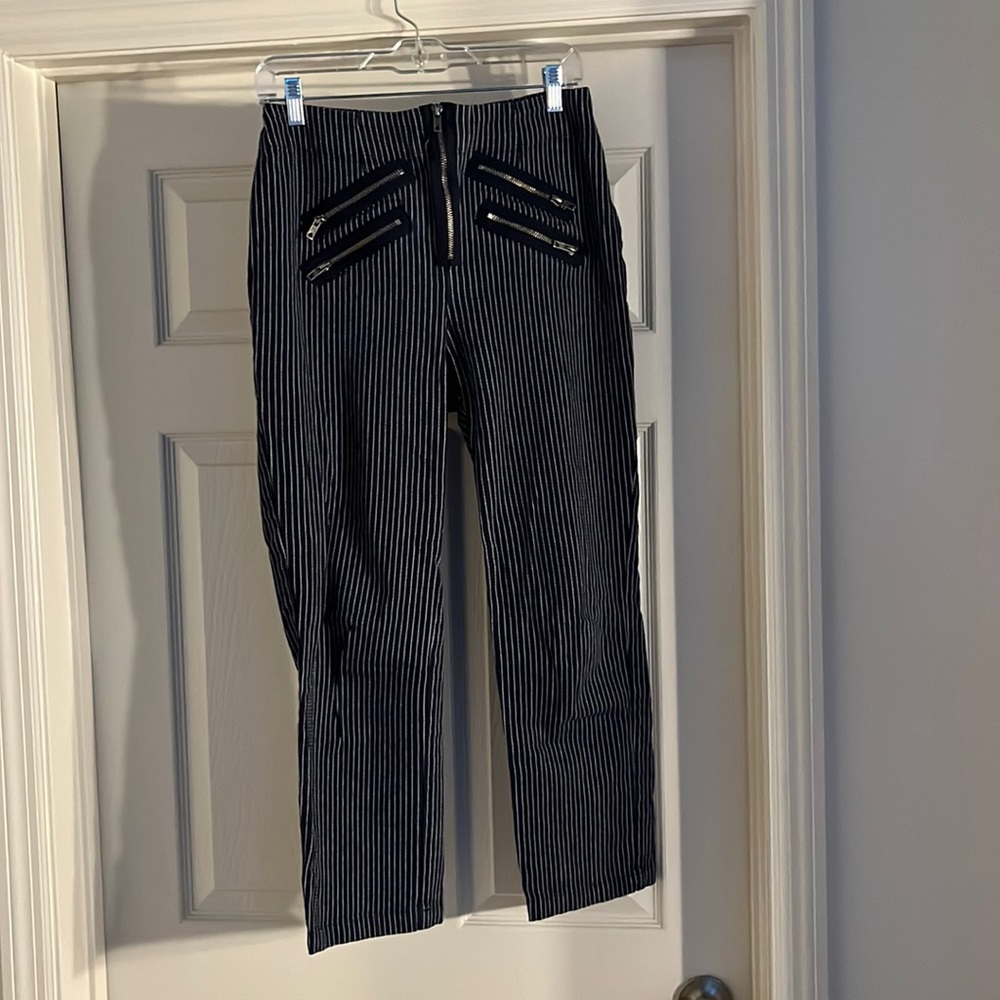 Navy blue and white pinstripe pants with decorative zippers
